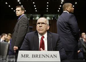 CIA Director nominee John Brennan, flanked by security, arrives today on Capitol Hill in Washington.