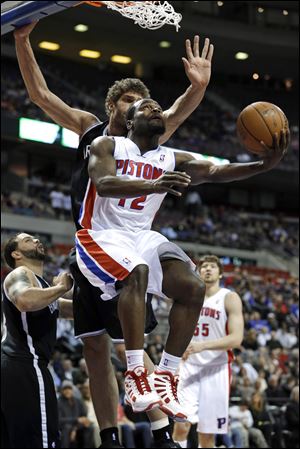 Detroit Pistons point guard Will Bynum drives on Brooklyn Nets center Brook Lopez on Wednesday in Auburn Hills, Mich.