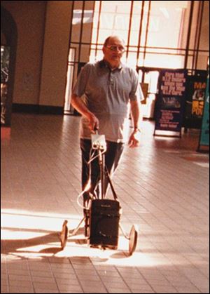 Butch Lemke's fight against beryllium disease includes walks with his oxygen tank attached to an old golf cart.
