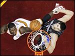  The Cavaliers' Dion Waiters, left, shoots over the Magic's Nikola Vucevic during the second quarter on Friday. It was the third straight win for Cleveland.