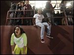  Two girls try to catch their breath after pepper spray was used to break up a fight during a basketball game inside Scott High School.