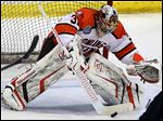  Bowling Green goalie Tommy Burke blocks a shot  against Michigan State. The Falcons’ netminder finished with 17 saves in a 2-1 win.