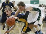  Toledo Christian School player Eric Cellier, 5, and Ottawa Hills High School player Blake Pappas, 1, battle for a loose ball.
