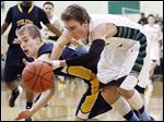  Toledo Christian's Eric Cellier, left, battles with Ottawa Hills'  Blake Pappasfor a loose ball at Ottawa Hills High School.