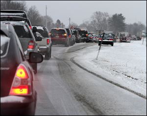 Cars are stuck in traffic as a winter storm arrives in Newington, N.H. Snow began to fall around the Northeast on Friday at the start of what's predicted to be a massive, possibly historic blizzard, and residents scurried to stock up on food and supplies ahead of the storm. 