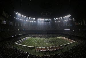 Fans and members of the Baltimore Ravens and San Francisco 49ers wait for power to return in the Superdome.