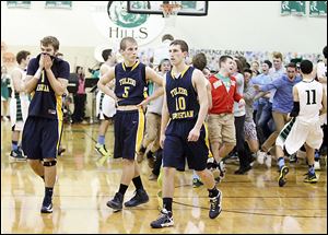 Toledo Christian's Ben Ivan (11), Eric Cellier (5), and Josh Winzeler leave the court after being denied a share of the conference title by Ottawa Hills.