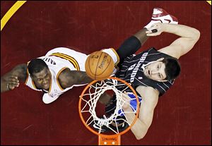 The Cavaliers' Dion Waiters, left, shoots over the Magic's Nikola Vucevic during the second quarter on Friday. It was the third straight win for Cleveland.