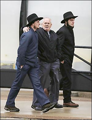 Amish men walk to the U.S. Federal Courthouse in Cleveland. Nine men and  six women were sentenced on Friday.