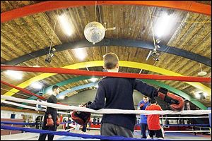 Juston Garcia, 12, of East Toledo waits for his turn to work with Cody Houghtalling at the International Boxing Club, which moved to Oregon a year ago.