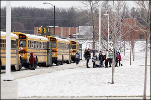 Students wait to get on buses near Maplewood Elementary School Friday in Sylvania. Two reports of a man in a white van attempting to lure children have been reported to police over the past two weeks in Sylvania. In both instances, the children ran away and the authorities were contacted.