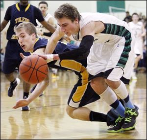 Toledo Christian's Eric Cellier, left, battles with Ottawa Hills'  Blake Pappasfor a loose ball at Ottawa Hills High School.