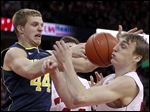  Michigan's Max Bielfeldt, left, and Wisconsin's Sam Dekker vie for a rebound during the first half of an NCAA college basketball game.