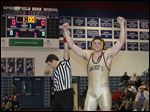  Perrysburg wrestler Mark Delas celebrates his win over Maumee's Nick Grzegorzeski during their 220-pound final match today at the Northern Lakes League wrestling championships at Springfield High School.
