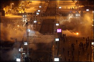 Egyptian security police fire tear gas at protesters during clashes next to the presidential palace in Cairo.