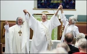 Joan Houk, bishop for the Great Waters Region, left, and the Rev. Elsie McGrath, regional program coordinator, right, presented newly ordained Deacon Beverly Bingle in September.  