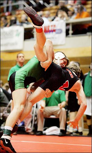 Delta junior James Dailey lifts Versailles' Corey Dieringer in the 120-pound match of the state team semifinals at OSU's St. John Arena.