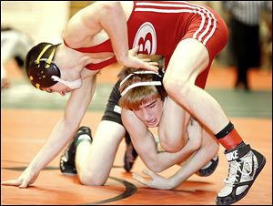 Clay sophomore Richie Screptock grabs the leg of Brecksville's Matt Topoly at 120 pounds in the Division I state team tournament opening round.