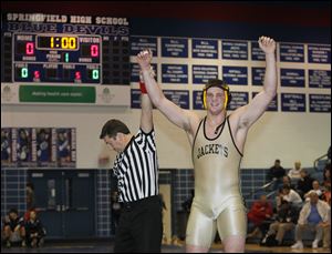 Perrysburg wrestler Mark Delas celebrates his win over Maumee's Nick Grzegorzeski during their 220-pound final match today at the Northern Lakes League wrestling championships at Springfield High School.