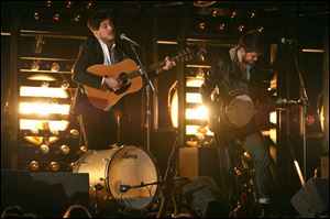 Marcus Mumford, left, and Winston Marshall, of Mumford & Sons perform at the 55th annual Grammy Awards on Sunday in Los Angeles. Mumford & Sons' 