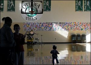 A banner created by students in memory of Brian Hoeflinger hangs in the Ottawa Hills gym. 