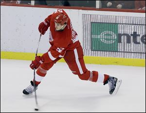 The Red Wings’ Jonathan Ericsson shoots the game-winning goal during the third period against the Los Angeles Kings on Sunday at Joe Louis Arena. The shot trickled past L.A. goalie Jonathan Quick with 4.5 seconds remaining in the contest.