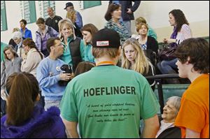 Tyler Grandsko, 18, center, who played golf with Brian Hoeflinger, was one of several students who turned out Saturday afternoon for the Ottawa Hills girls basketball game with t-shirts in remembrance of the 18 year-old Ottawa Hills senior.