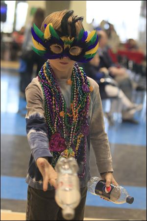 Timmy Horvat, 8, of Perrysburg at the Environmental Club's contest at Mardi Gras. The French Club of Perrysburg Hiigh School hosted a Mardi Gras at the school today. About 300 were expected to attend.