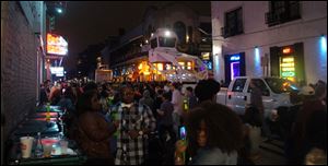 From a security tower above the Mardi Gras crowds, NOPD officers watch the 400 and 500 blocks of Bourbon Street after four people were shot around 9:30 p.m. Saturday, Feb. 9, 2013.