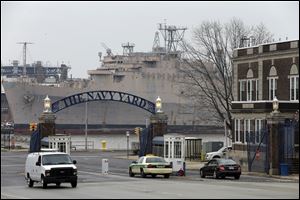 Vehicles move thought the main gate at the Navy yard in Philadelphia.
