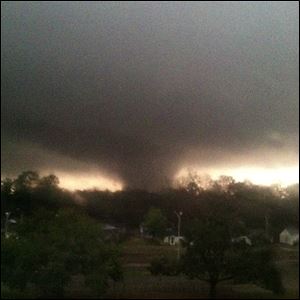 This photo provided by Jordan Holliman shows a tornado moving through Hattiesburg, Miss., Sunday.