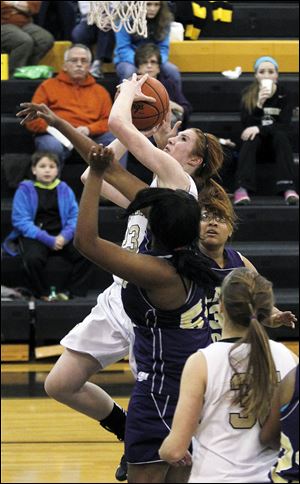 Perrysburg's Sarah Baer shoots over Waite's Latesha Craig. The junior center led the Yellow Jackets with 17 points.