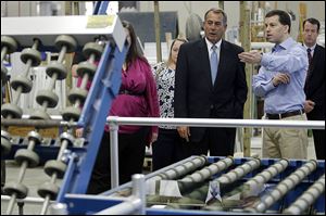 House Speaker John Boehner of Ohio tours Vinylmax LLC with vice president and owner Craig Doerger, right, Monday in Hamilton, Ohio. Vinylmax is a top window producing company.