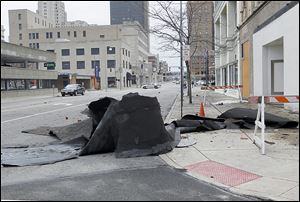A section of Jefferson Avenue was closed on Monday after parts of the former  Caesar's Show Bar fell onto the street and sidewalk because of wind gusts. Inspectors will try to determine the extent of damage and the structure's integrity before reopening the street.