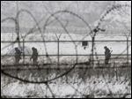  South Korean army soldiers patrol along barbed-wire fences at the Imjingak Pavilion, near the demilitarized zone of Panmunjom, in Paju, South Korea, Tuesday, Feb. 12, 2013. South Korea is confirming that North Korea has tested a nuclear device in defiance of U.N. orders to stop building atomic weapons. (AP Photo/Ahn Young-joon)