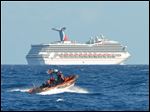  A small boat belonging to the Coast Guard Cutter Vigorous patrols near the cruise ship Carnival Triumph in the Gulf of Mexico, Monday.