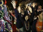  Revelers yell for beads and trinkets during the Krewe of Orpheus Mardi Gras parade in New Orleans, Monday.