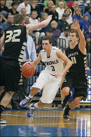 AW’s Matt Fox, center, drives past Perrysburg’s Bryant Byrd, right, and Chris Schimmoeller. Fox, who scored 14 points, sank four free throws during the final 33.9 seconds to seal the win.