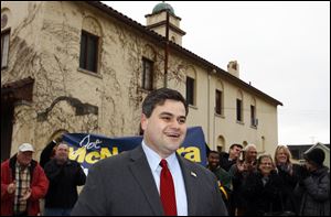 Toledo City Council President Joe McNamara smiles and his supporters applaud as he announces his decision to run for mayor of Toledo during a news conference in front of the Toledo fire department's closed Station 3.