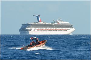 A small boat belonging to the Coast Guard Cutter Vigorous patrols near the cruise ship Carnival Triumph in the Gulf of Mexico, Monday.