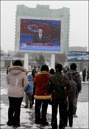 On a large television screen in front of Pyongyang's railway station, a North Korean state television broadcaster announces the news that North Korea conducted a nuclear test today.