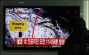 A South Korean passenger watches TV news reporting an earthquake in North Korea after an underground atomic test, at the Seoul train station in Seoul, South Korea, today. The U.S. Geological Survey today detected a magnitude 4.9 earthquake in North Korea. 
