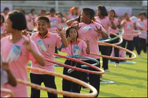 Participants perform in a hula hoop competition to break the Guinness World Record for most people dancing with hula hoops, at Thammasat University, Pathumthani, Thailand  Tuesday.