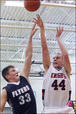 Otsego junior John Thomas shoots over Jayce Vancena. Thomas averages 12.3 points and 6.9 rebounds.