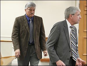 St. John's coach Ed Heintschel, left, appears in Maumee Municipal Court with attorney Richard Hasbrook. A judge rescheduled a pretrial until April 2.