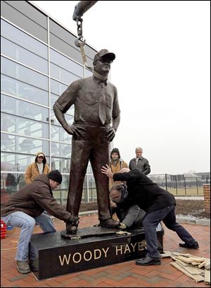 A statue of Woody Hayes is moved into place at the east entrance of the Woody Hayes Athletic Center in Columbus. Hayes had a record of 205-61-10 with the Buckeyes and won three national titles.