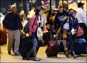 Passengers from the disabled Carnival Triumph cruise ship arrive by bus today at the Hilton Riverside Hotel in New Orleans.