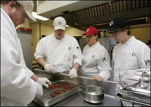 Owens Community College culinary students prepare lunch at the Perrysburg Township school’s Terrace View Cafe. Ohio has reduced aid to higher education, putting more of a burden on students and their families.