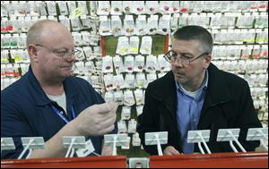 Salesman John Jokinen, left, helps Gordon Cepnick, of West Bloomfield, Mich., select a treble hook for crank baits at Jann's Netcraft. 'Our customers tinker,' Mr. Jokinen says. 'They buy something off the rack, and they're changing it.' Mr. Cepnick started his own lure company last year.