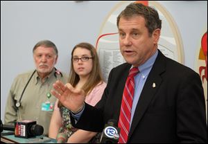 U.S. Sen. Sherrod Brown announces plans to introduce bipartisan legislation to ensure that the NIH investment in pediatric research enhances collaboration to stretch limited research dollars during a news conference at Toledo Children's Hospital. Looking on are Dr. Pierre Vauthy, Director of Pedicatric Pulmonary Medicine at Toledo Children's Hospital, and Rachel Burns, a 15-year-old Springfield High School student and cystic fibrosis patient. 